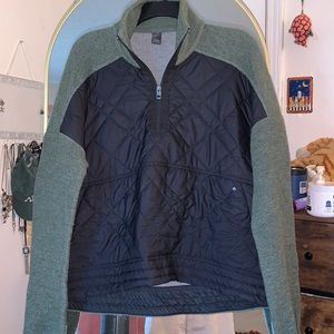 prAna army green sweater with black quilted insulation detailing.